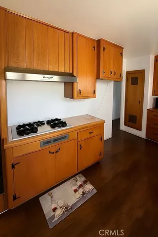 a kitchen with stainless steel appliances wooden cabinets a stove and a refrigerator