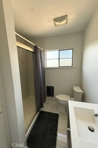 a bathroom with a toilet and a shower