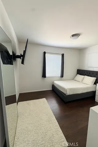 a bedroom with a bed and a large mirror