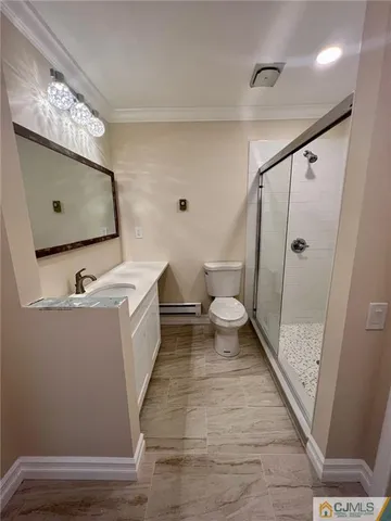 a bathroom with a sink a toilet a mirror and shower