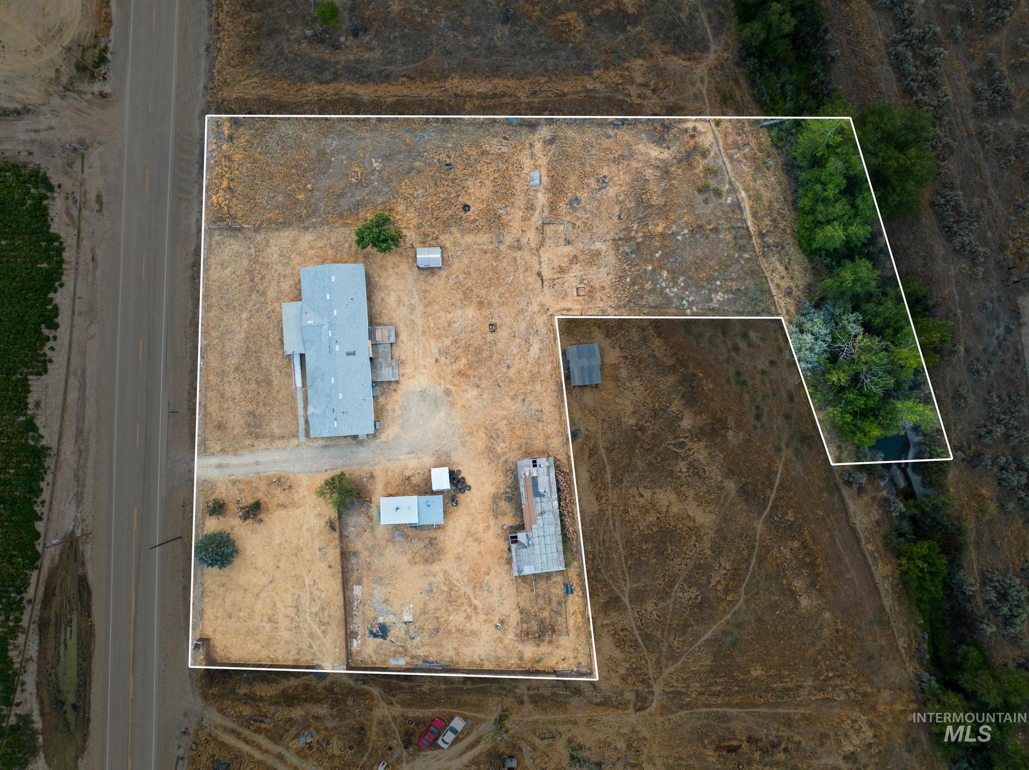 15190 Oasis Road Caldwell, ID 83607 - Photo 35 of 36 Expansive property with a residence, multiple outbuildings, mature trees, and direct road frontage