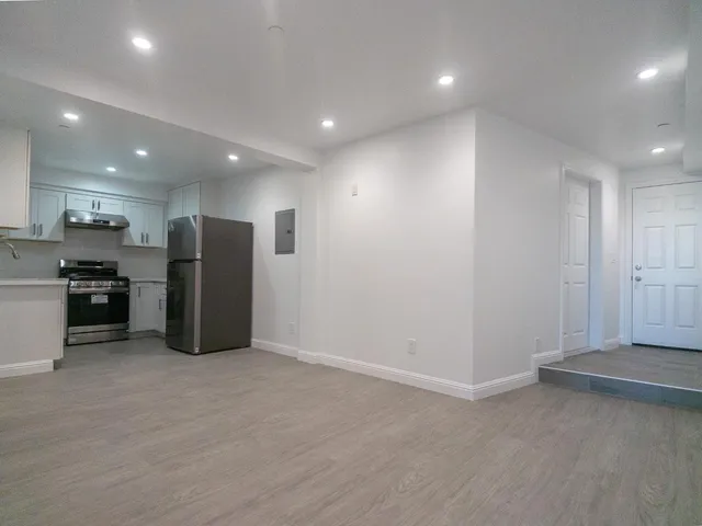 a view of kitchen with refrigerator and microwave
