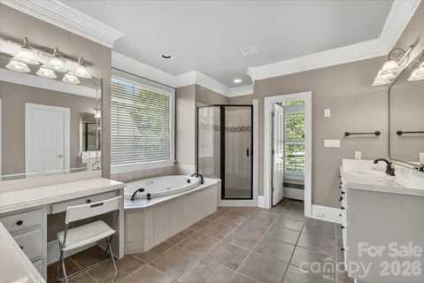 a bathroom with a tub sink shower and mirror