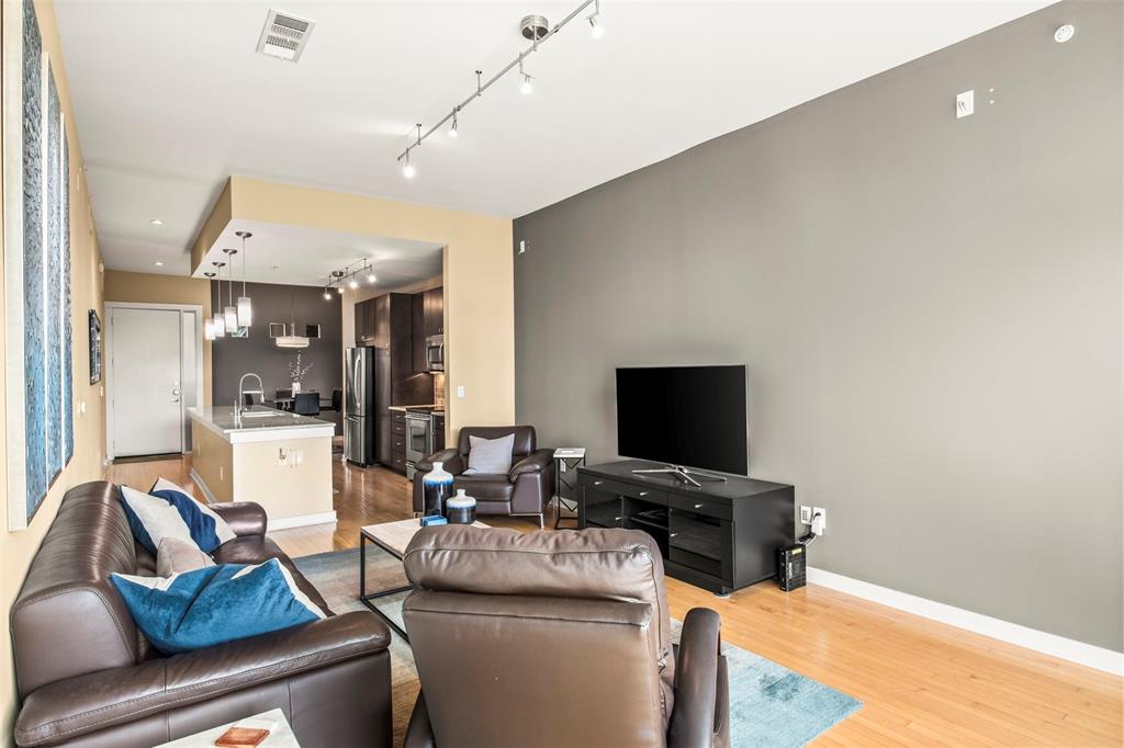 2950 McKinney Avenue, Unit 412 Dallas, TX 75204 - Photo 14 of 26 a living room with furniture and a flat screen tv