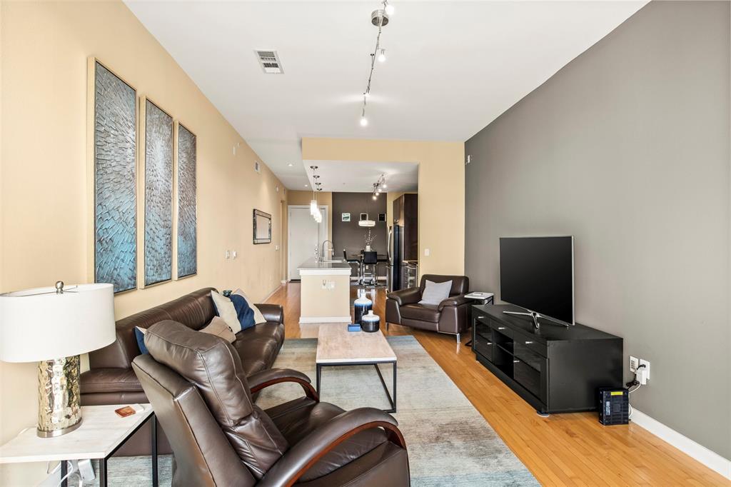 2950 McKinney Avenue, Unit 412 Dallas, TX 75204 - Photo 15 of 26 a living room with furniture a flat screen tv and a window