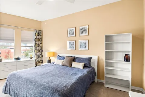 a bedroom with a large bed and a large window