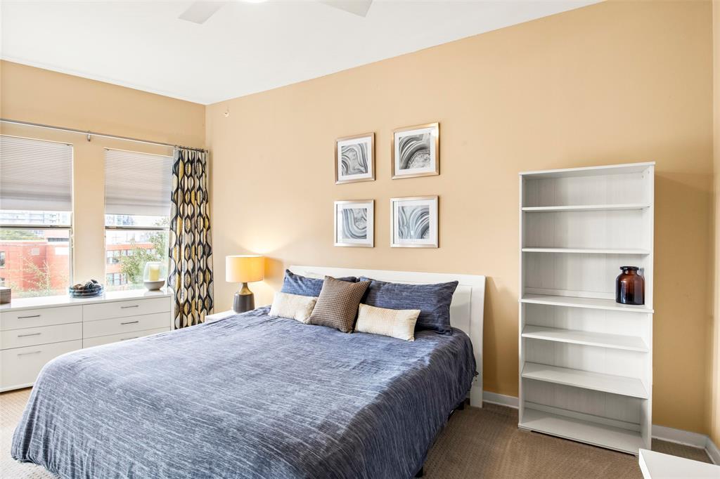 2950 McKinney Avenue, Unit 412 Dallas, TX 75204 - Photo 21 of 26 a bedroom with a large bed and a large window