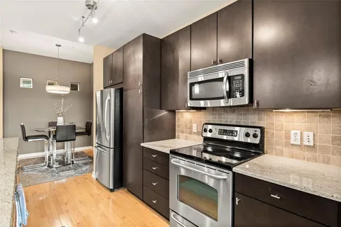 a kitchen with a refrigerator stove and microwave