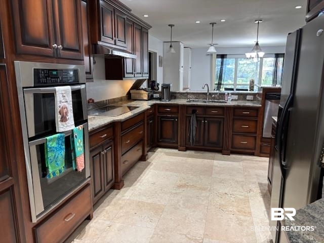 7310 Cook Road Foley, AL 36535 - Photo 12 of 14 Kitchen featuring black appliances, dark brown cabinets, decorative light fixtures, recessed lighting, and dark stone countertops