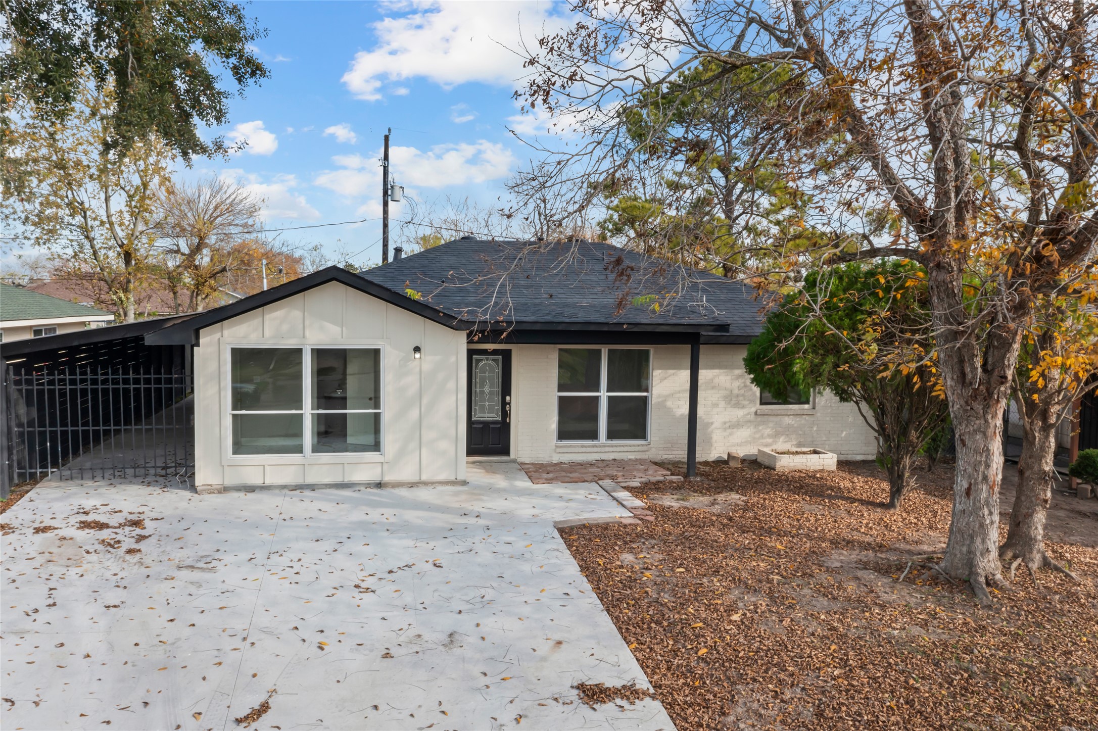 12707 Southbridge Road Houston, TX 77047 - Photo 1 of 23 a front view of a house with a garden and trees