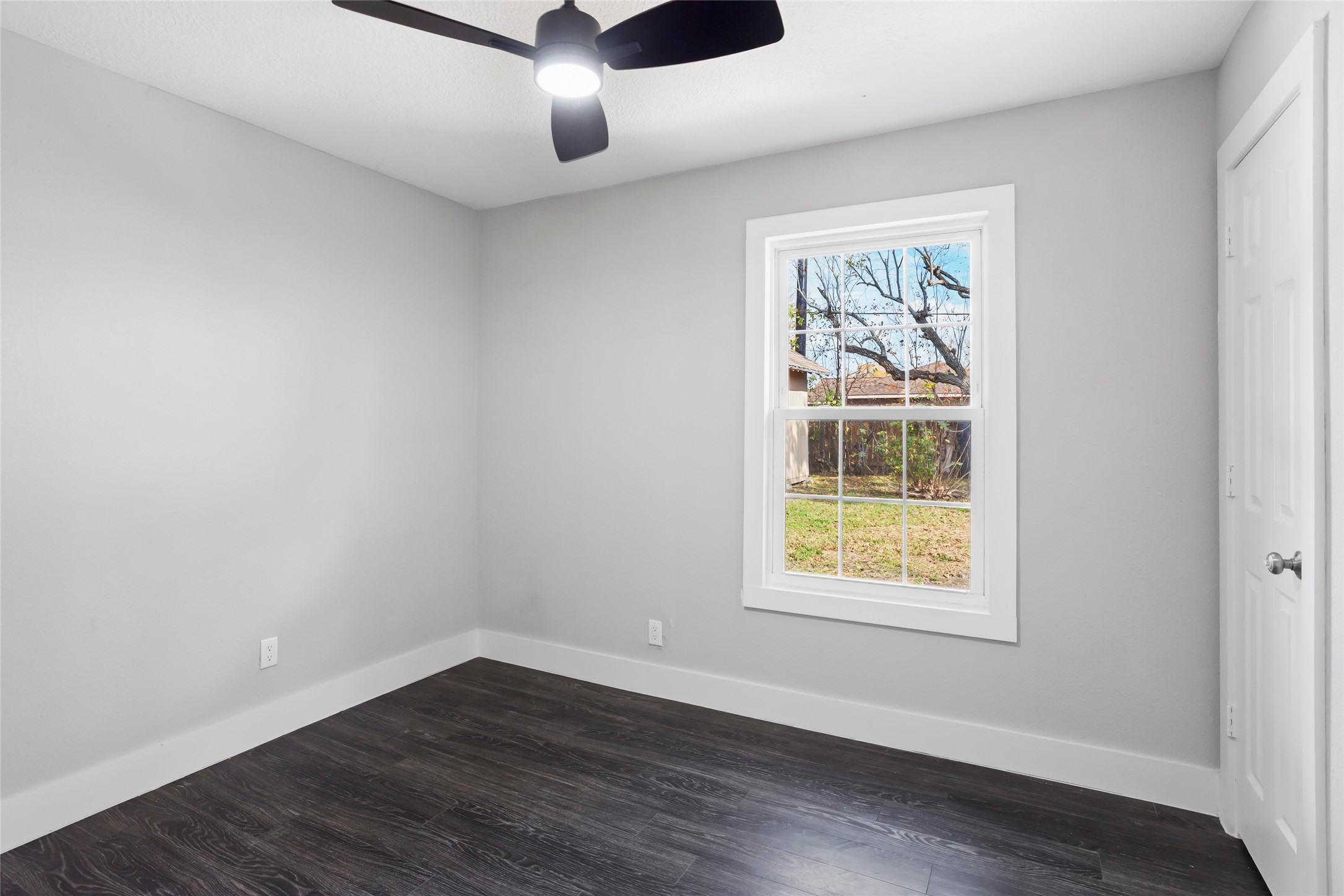 12707 Southbridge Road Houston, TX 77047 - Photo 16 of 23 an empty room with wooden floor chandelier fan and windows