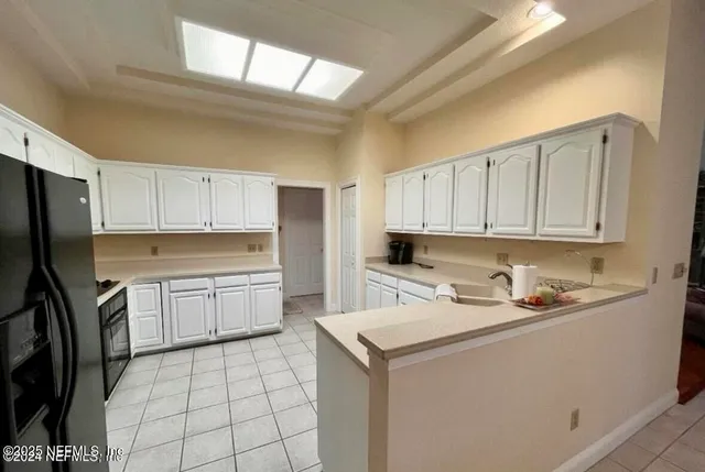 a kitchen with a sink appliances and cabinets
