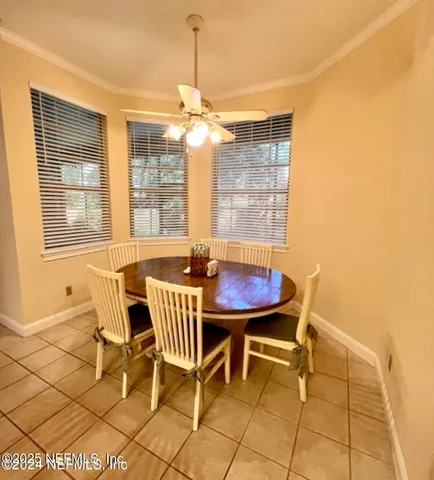 a view of a dining room with furniture and window