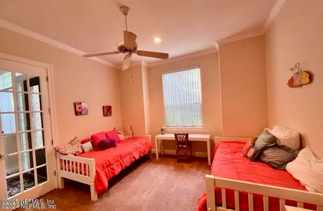 a bedroom with a bed couch and a window