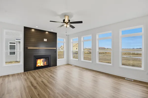 a view of an empty room with a fireplace and a window