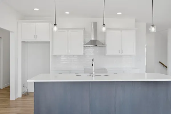 a view of a kitchen with a sink and wooden cabinets