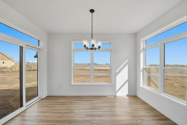 a view of a room with window wooden floor and chandelier