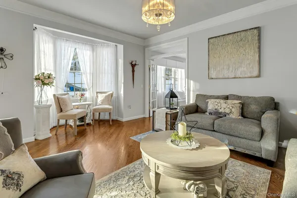 a living room with furniture a table and a chandelier