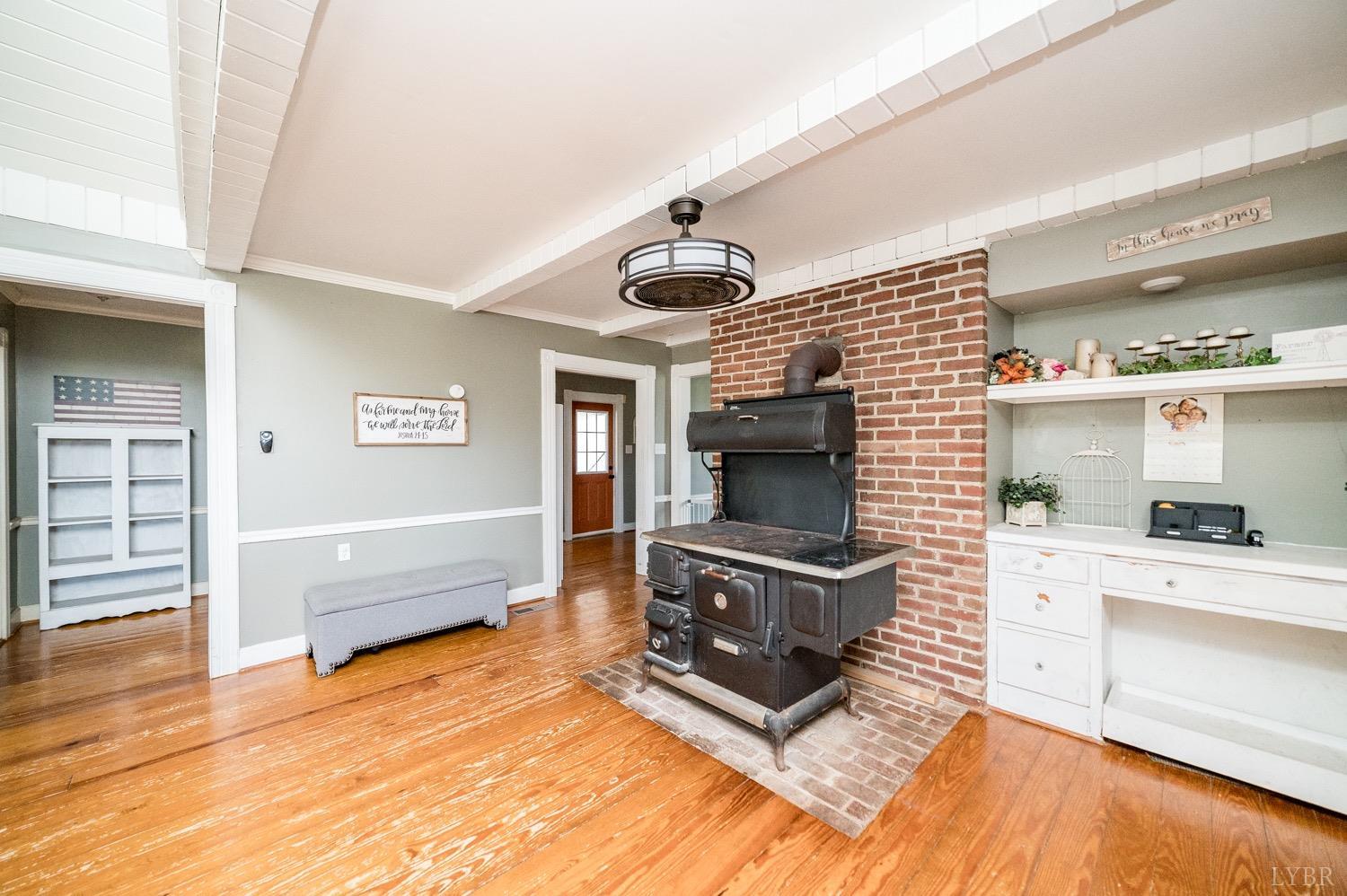 1103 Manley Branch Road Concord, VA 24538 - Photo 13 of 56 a living room with granite countertop furniture a fireplace and a wooden floor