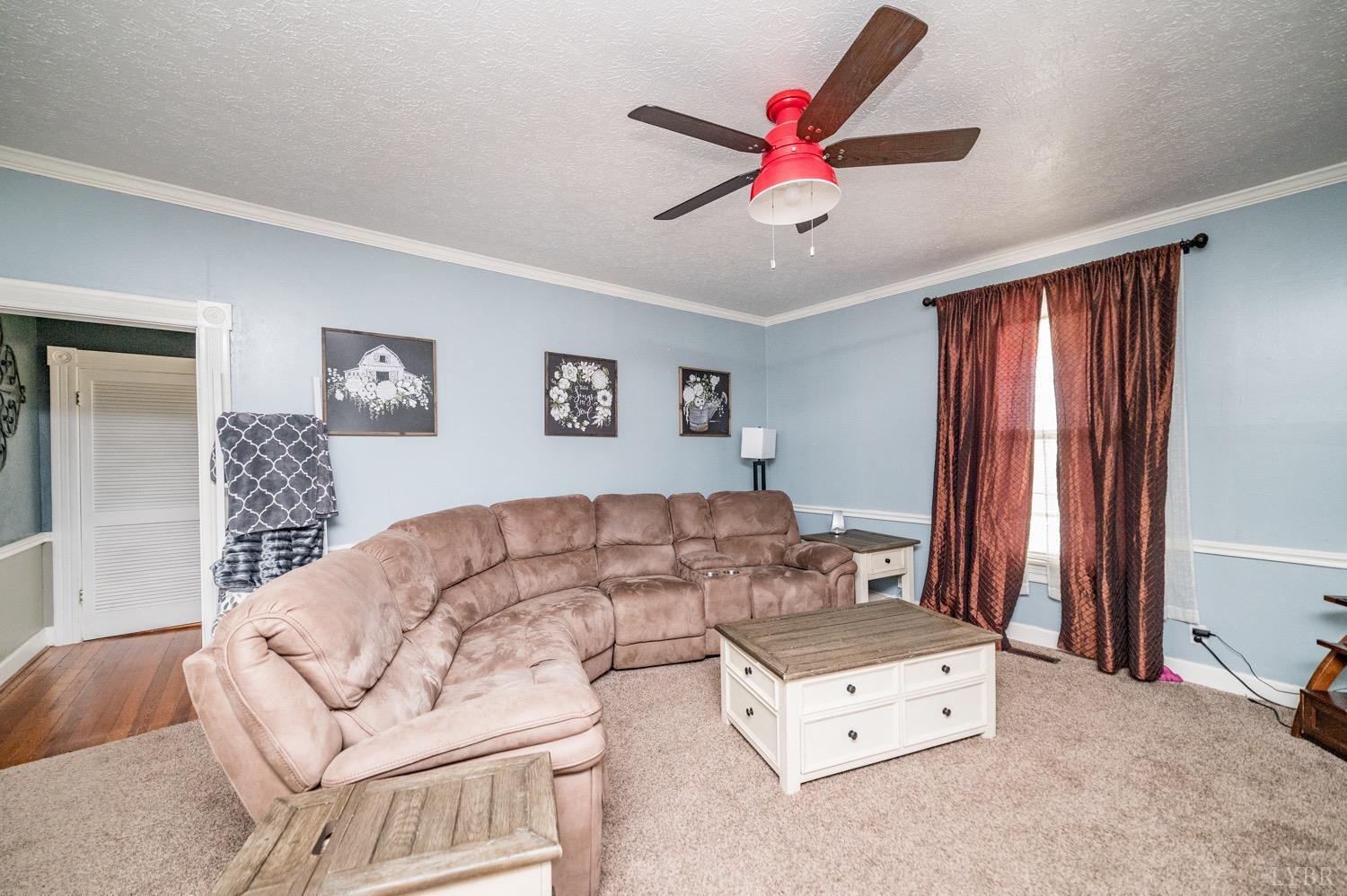 1103 Manley Branch Road Concord, VA 24538 - Photo 16 of 56 a living room with furniture and a chandelier