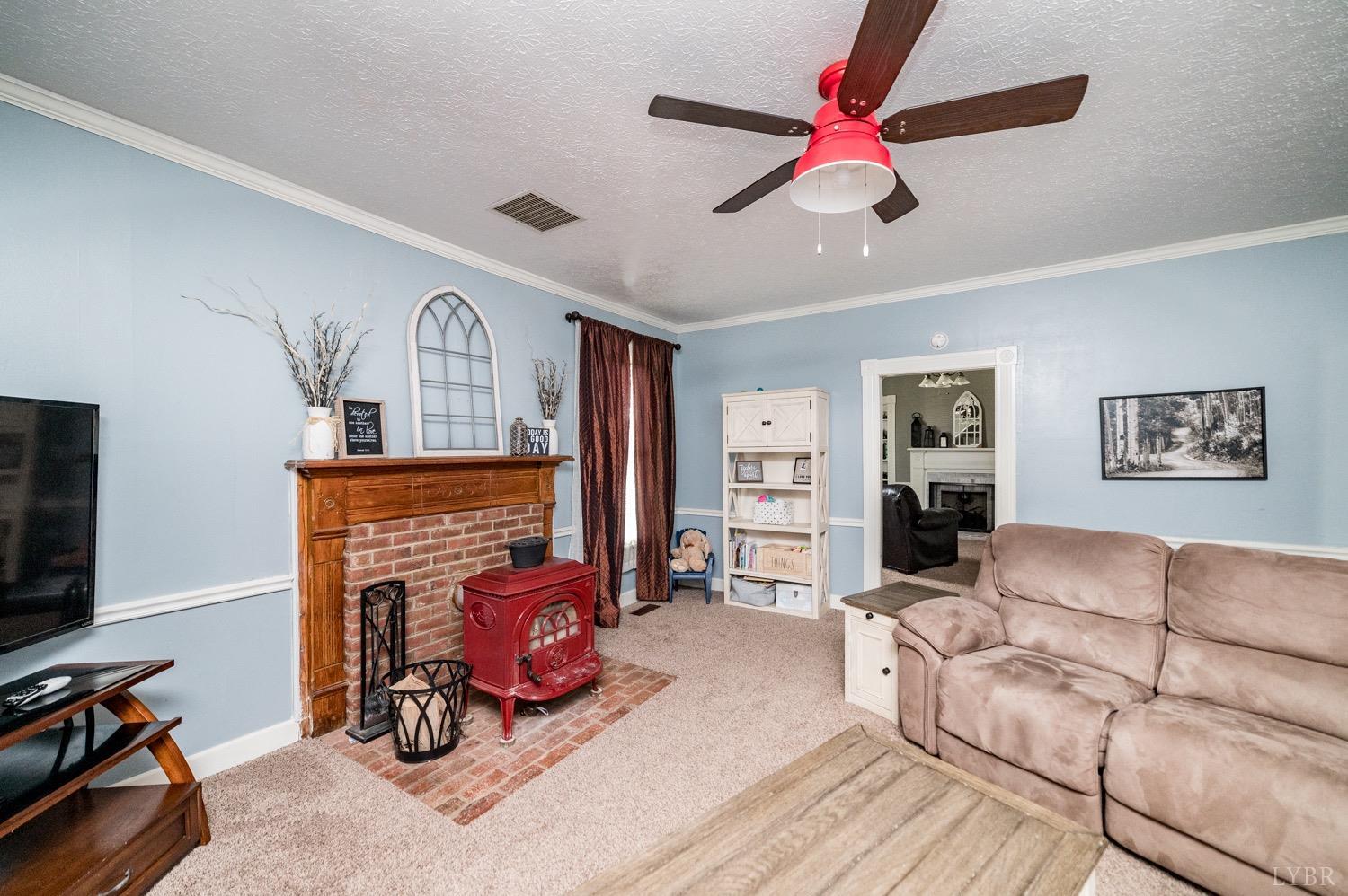 1103 Manley Branch Road Concord, VA 24538 - Photo 17 of 56 a living room with furniture a flat screen tv and a fireplace