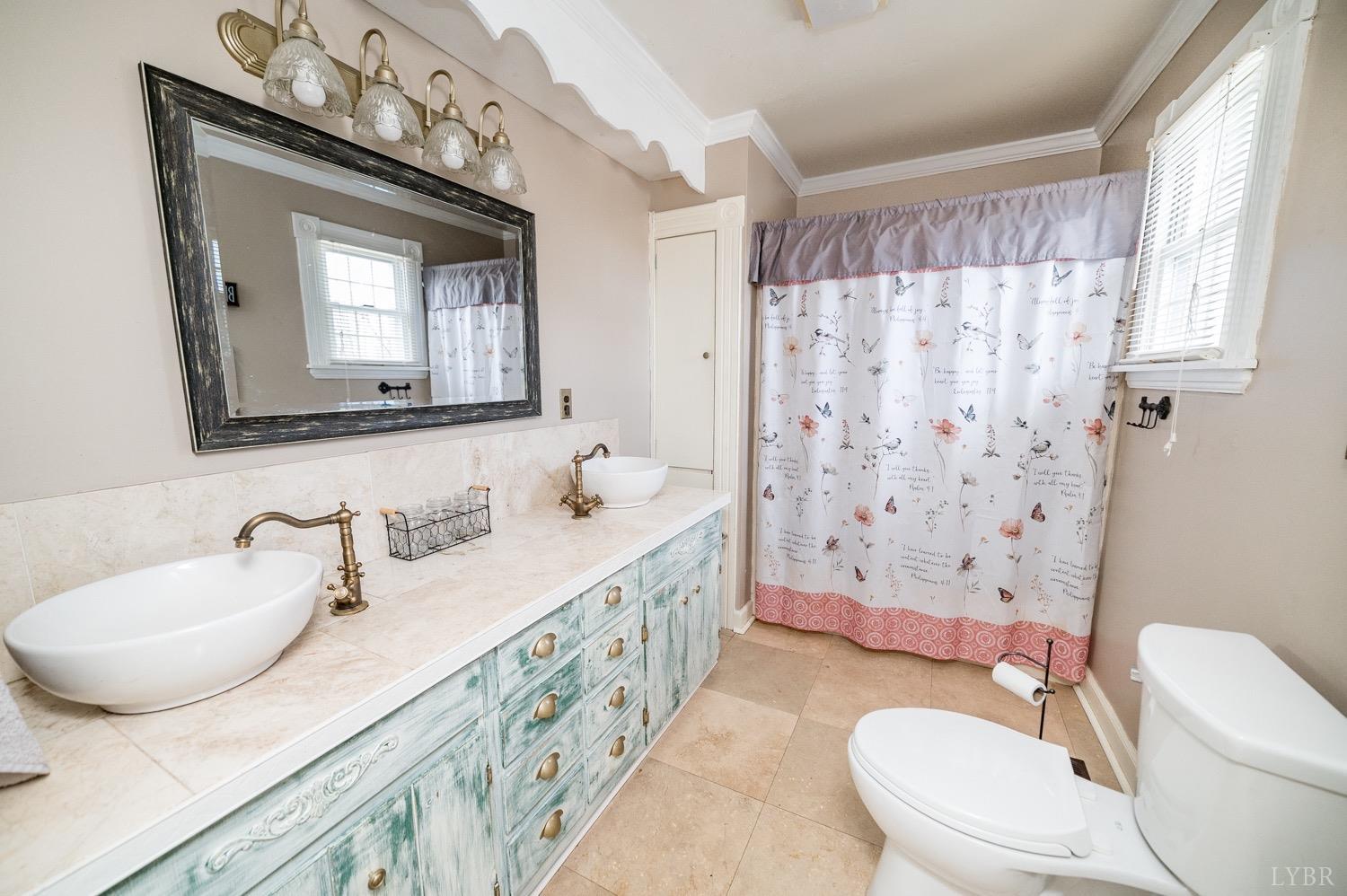 1103 Manley Branch Road Concord, VA 24538 - Photo 24 of 56 a bathroom with a granite countertop sink mirror a toilet and a shower