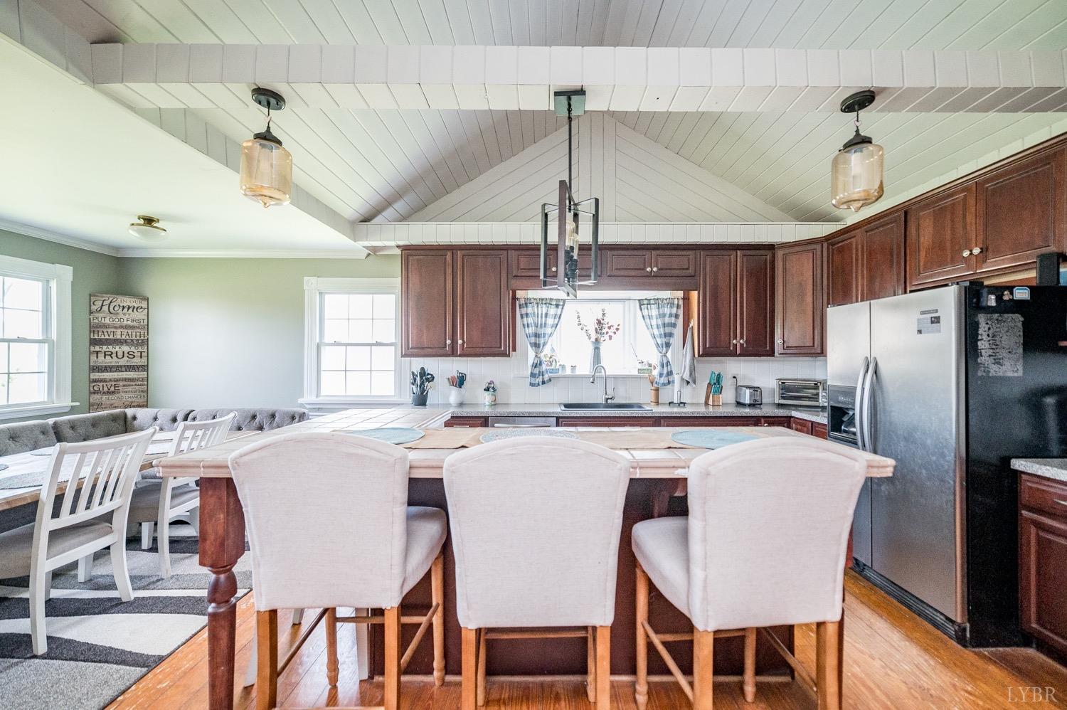 1103 Manley Branch Road Concord, VA 24538 - Photo 7 of 56 a kitchen with stainless steel appliances a dining table chairs and wooden floor
