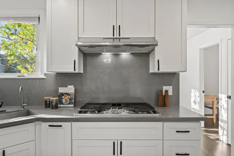 a kitchen with a stove and cabinets