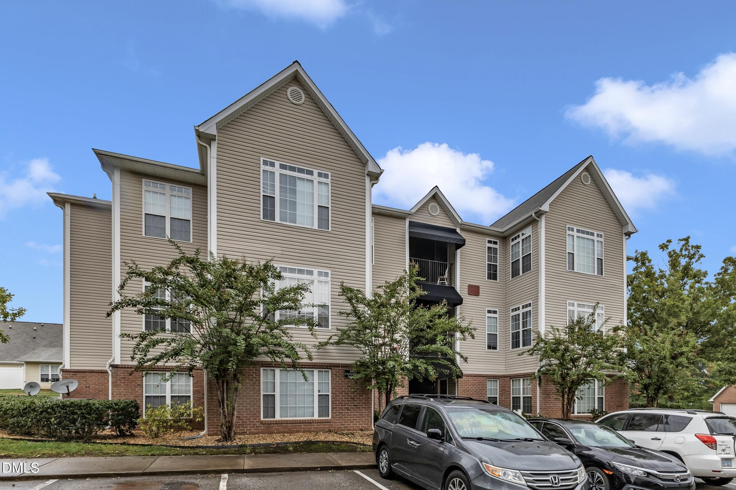 2521 Friedland Place, Unit 201 Raleigh, NC 27617 - Photo 1 of 34 a front view of a house with a yard