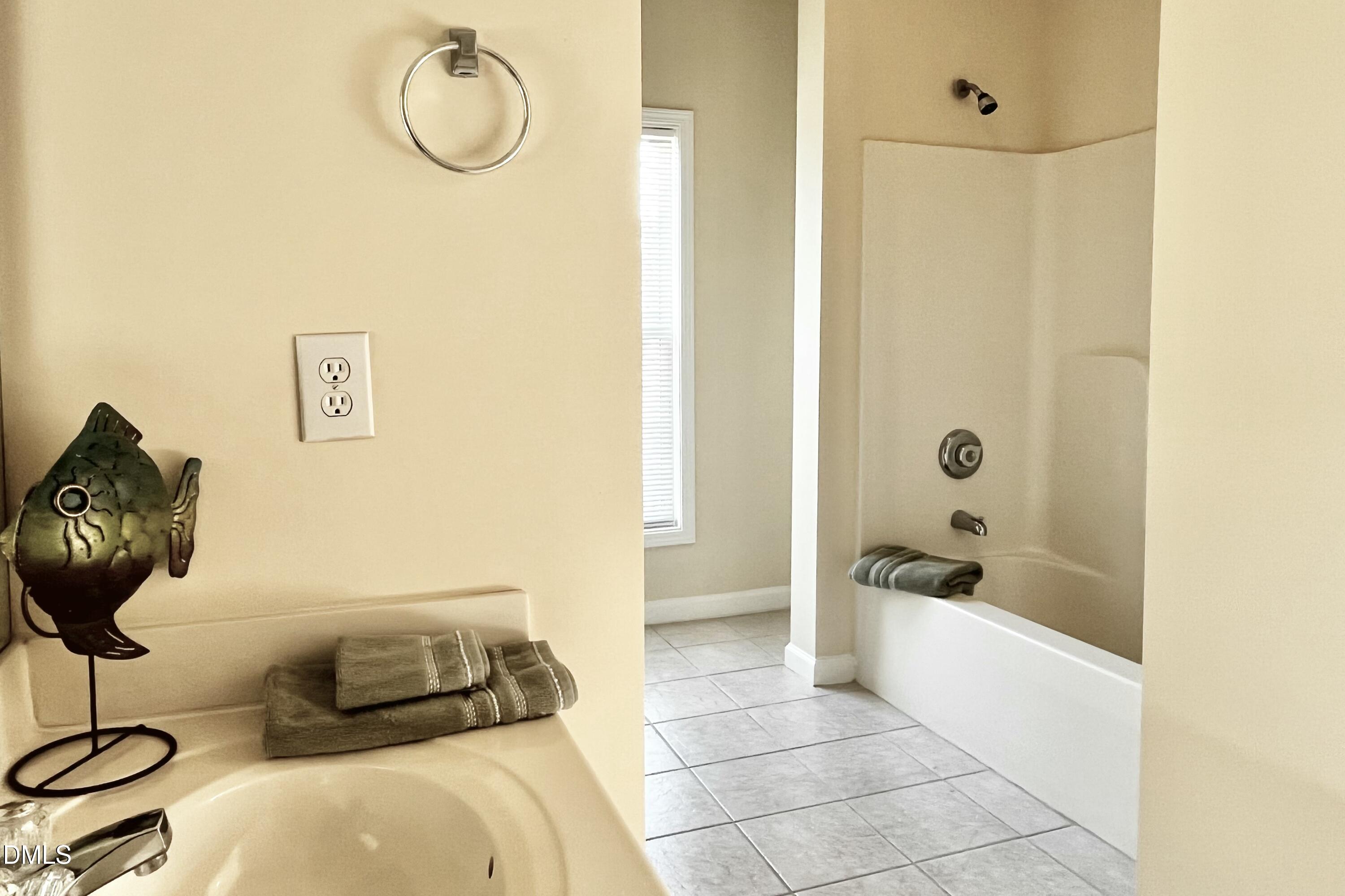 2521 Friedland Place, Unit 201 Raleigh, NC 27617 - Photo 19 of 34 a bathroom with a tub sink and shower
