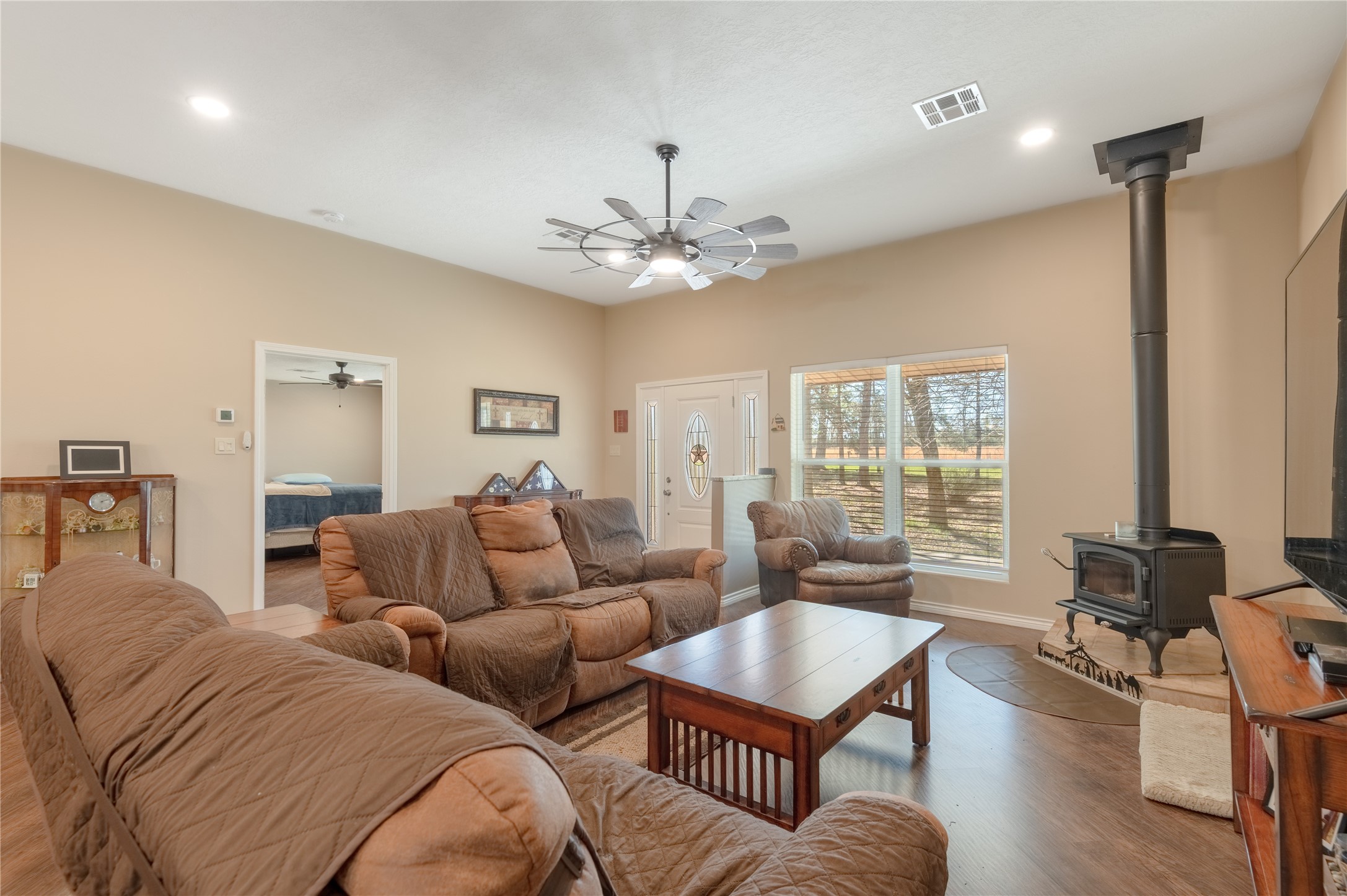 1533 Kickapoo Road Groveton, TX 75845 - Photo 7 of 50 a living room with furniture a large window and a chandelier