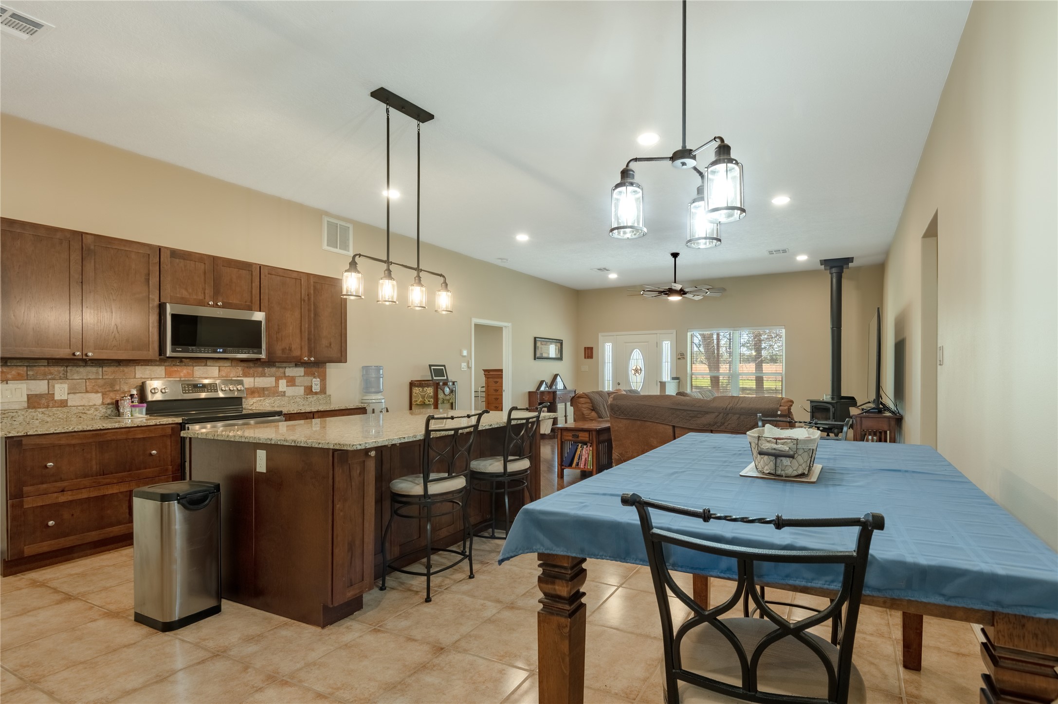 1533 Kickapoo Road Groveton, TX 75845 - Photo 10 of 50 a kitchen with kitchen island a dining table and chairs