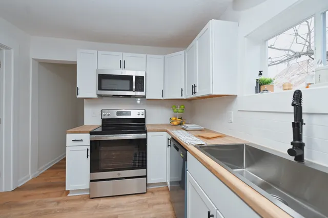 a kitchen with cabinets appliances and a sink