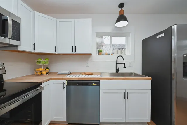 a kitchen with a sink cabinets and stainless steel appliances