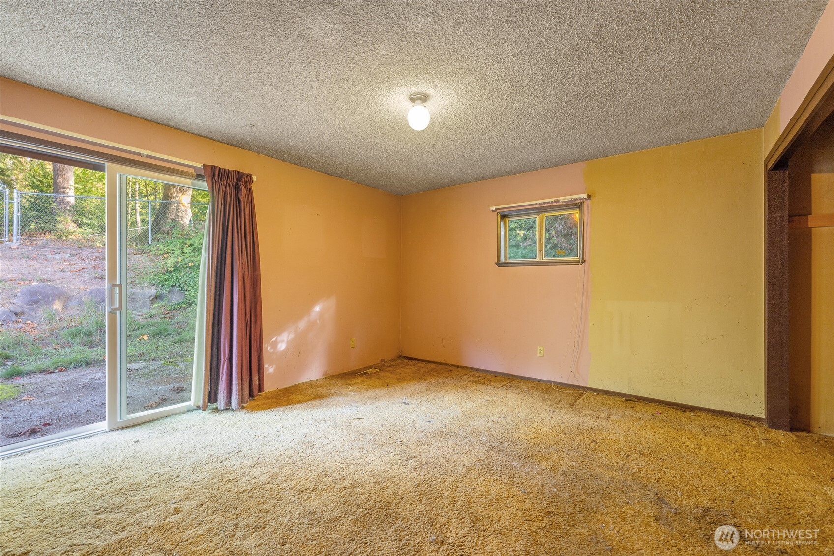 20822 Southeast 271st Street Covington, WA 98042 - Photo 17 of 30 a view of an empty room with wooden floor and a window
