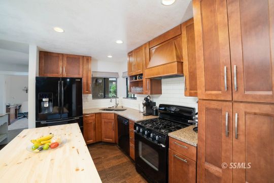 313 East Haloid Avenue Ridgecrest, CA 93555 - Photo 4 of 39 a kitchen with stainless steel appliances granite countertop a stove a sink and a microwave