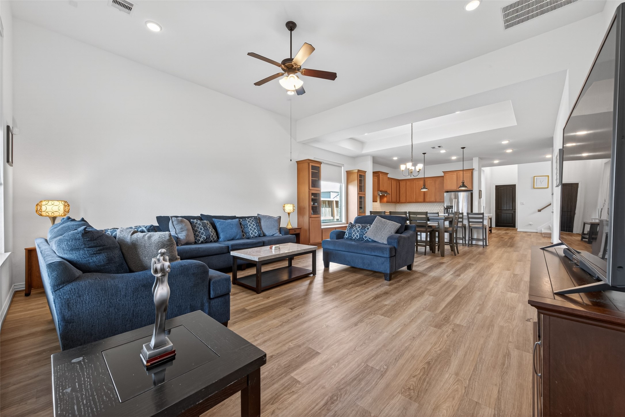 20802 Mirror Point Drive Cypress, TX 77433 - Photo 12 of 37 This generously sized living area boasts high ceilings and is well-illuminated by natural light and recessed lighting, creating a warm and inviting ambiance.