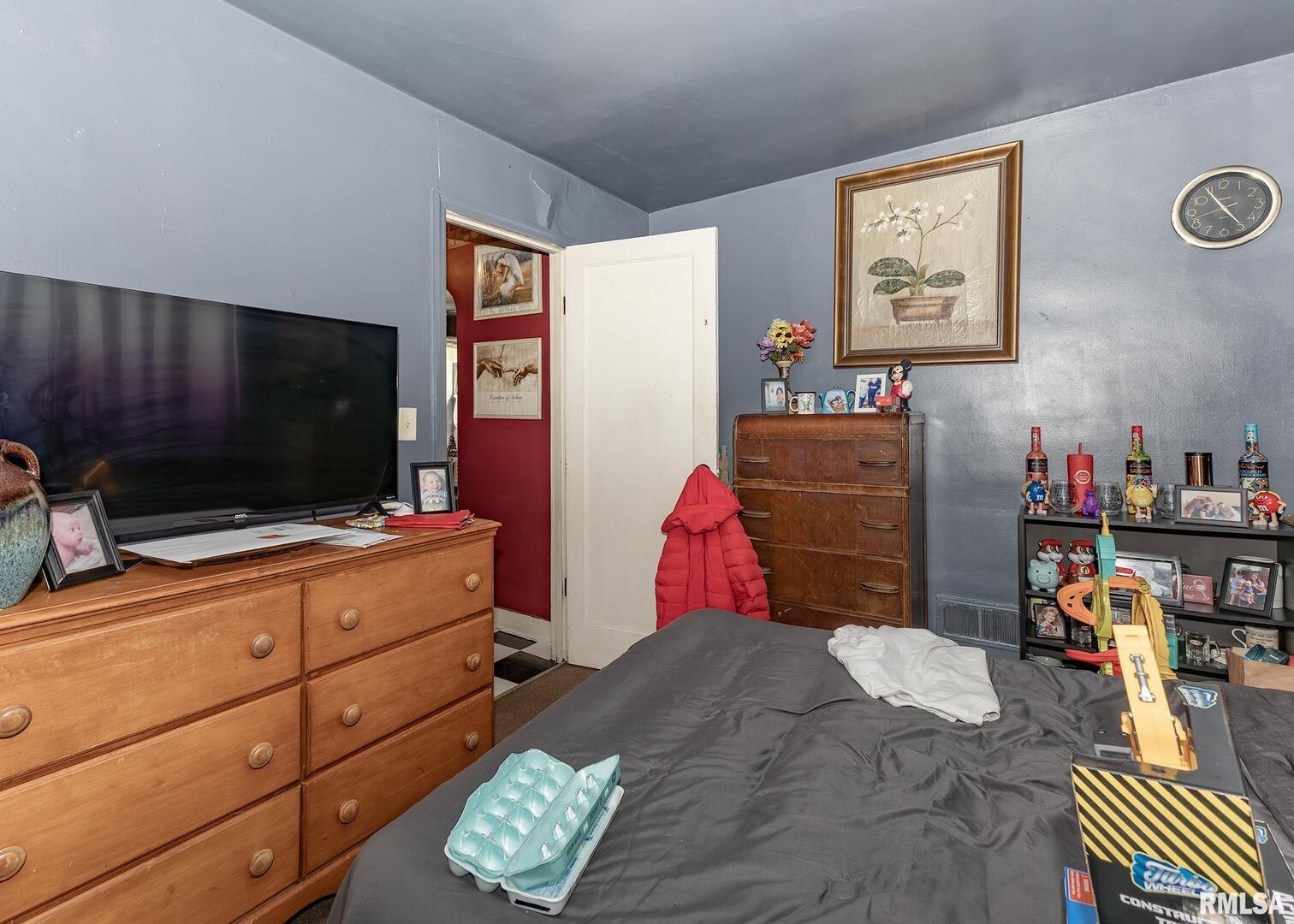 116 West Garfield Street Kewanee, IL 61443 - Photo 13 of 18 a bedroom with a bed and wooden floor