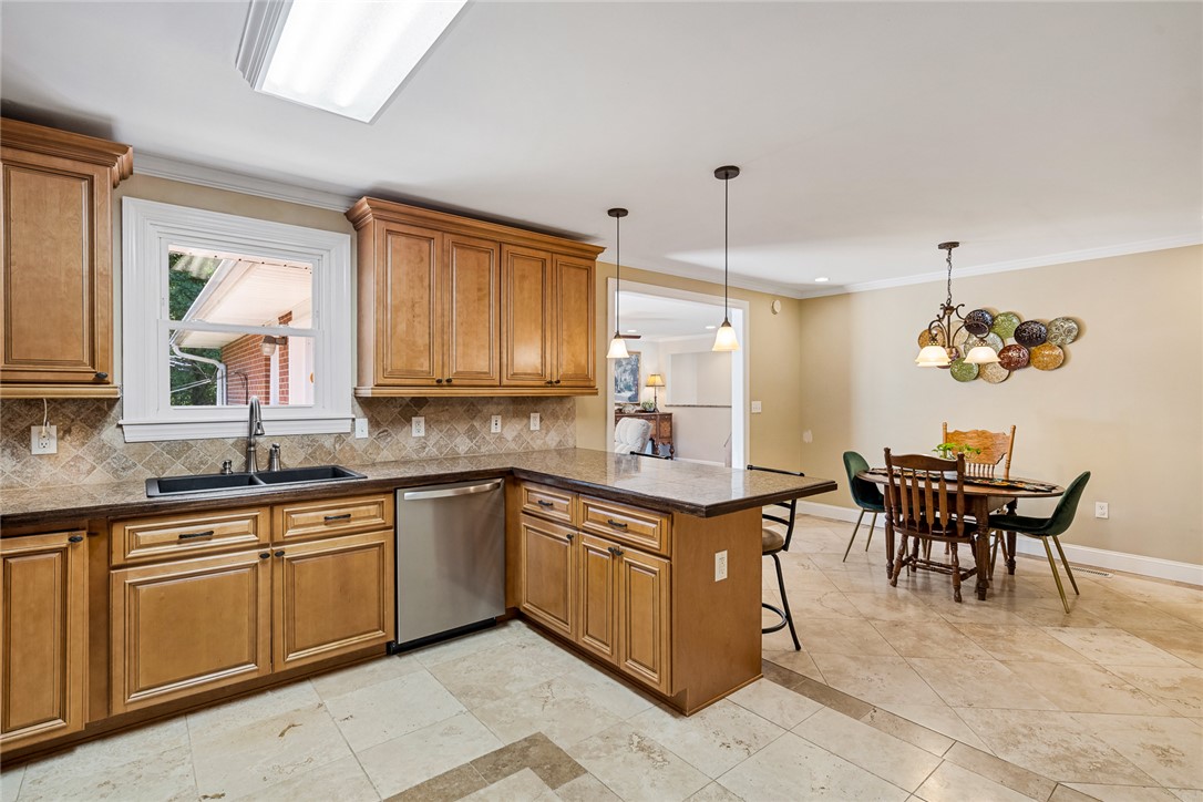 512 East Fredericks Street Anderson, SC 29621 - Photo 11 of 31 A well-appointed kitchen features warm wooden cabinetry and durable tile flooring, perfect for daily living and entertaining.