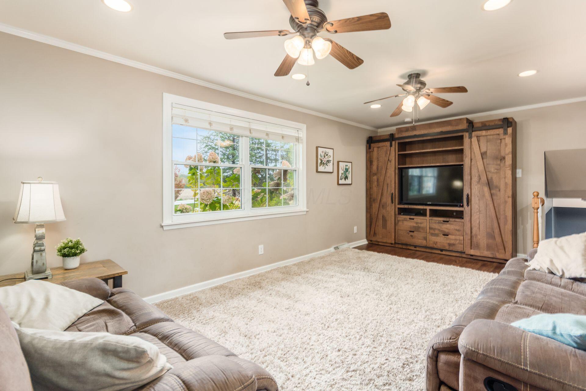 9221 London Road Orient, OH 43146 - Photo 14 of 51 Fantastic Family Room with oversized windows, overhead fan, and hardwood floors. Measures 12' x 22'3"