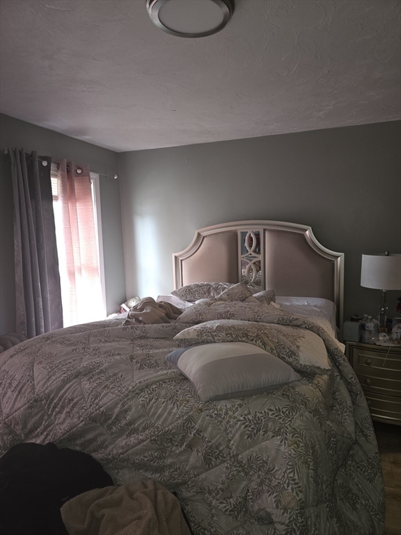 184 Myrtle Street Brockton, MA 02301 - Photo 9 of 10 a bedroom with a bed and a window