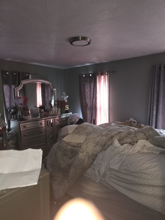 184 Myrtle Street Brockton, MA 02301 - Photo 10 of 10 a spacious bedroom with a large bed and a large mirror