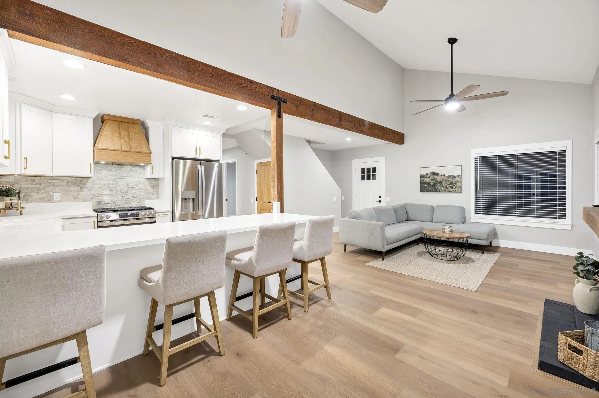 1590 Dorothea Avenue Fallbrook, CA 92028 - Photo 11 of 42 a living room with couches and kitchen view with wooden floor