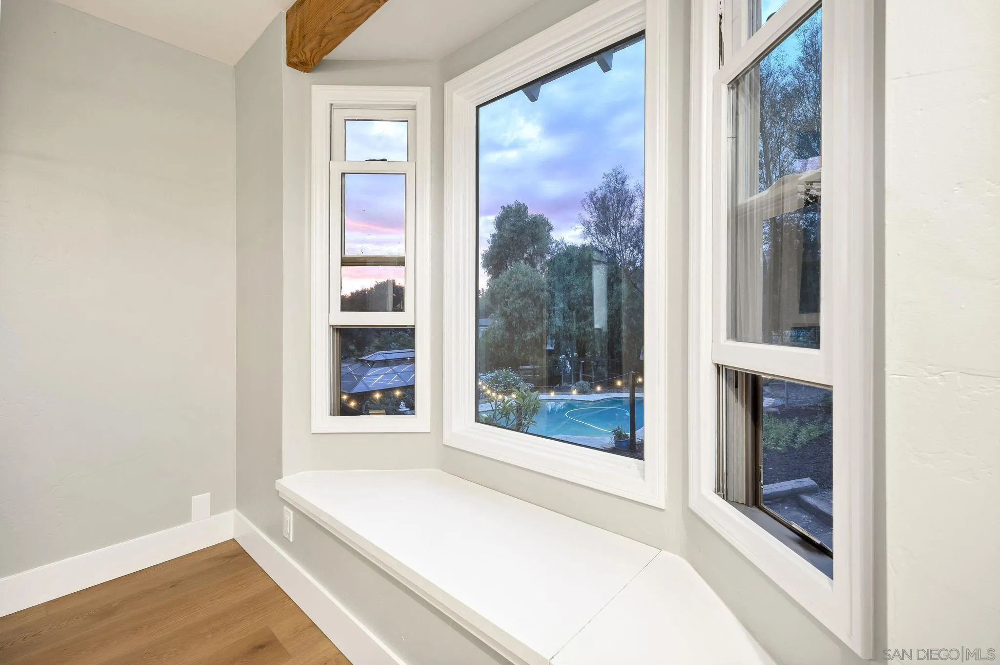 1590 Dorothea Avenue Fallbrook, CA 92028 - Photo 23 of 42 a view of an empty room with wooden floor and a window