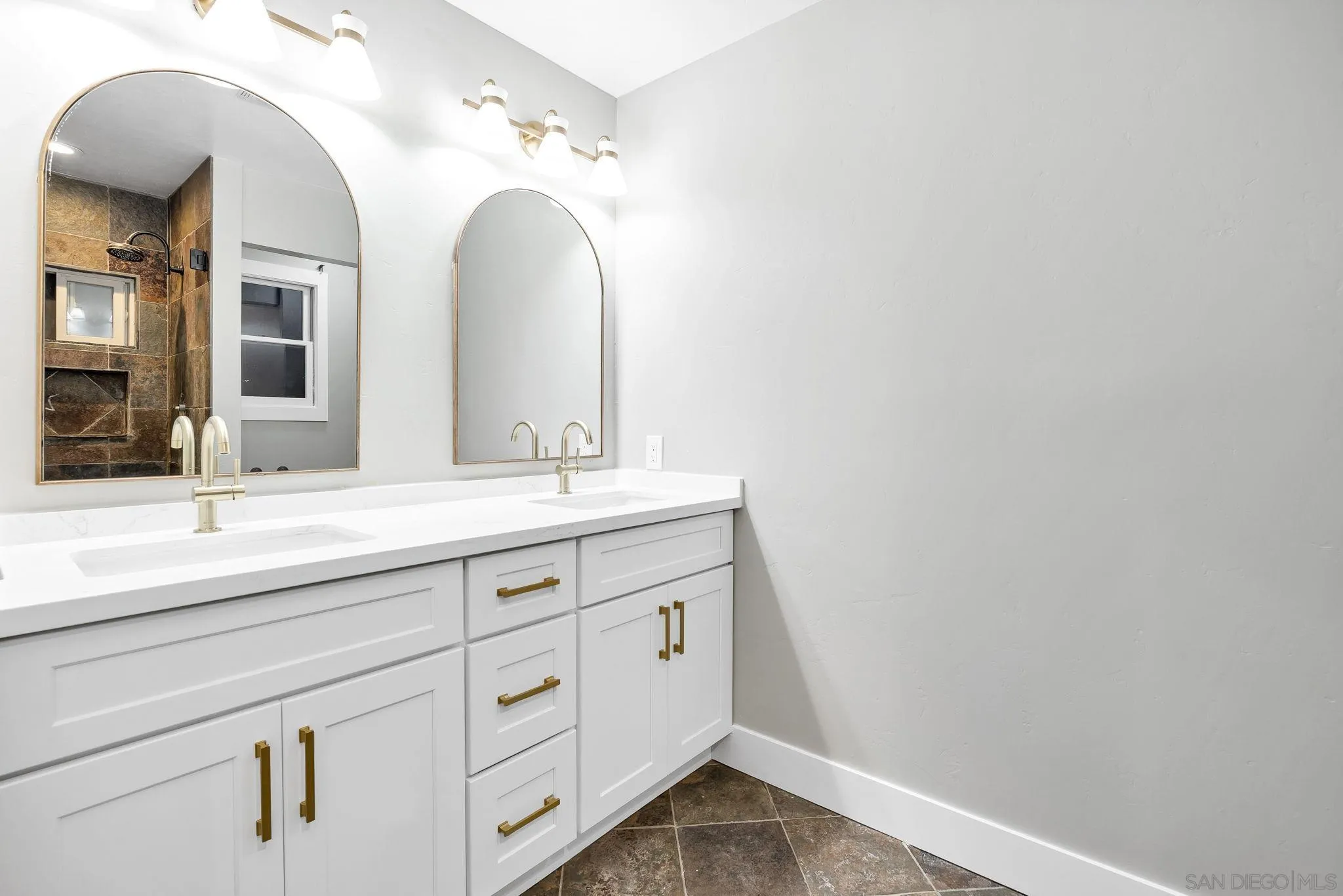 1590 Dorothea Avenue Fallbrook, CA 92028 - Photo 27 of 42 a bathroom with a double vanity sink and a mirror