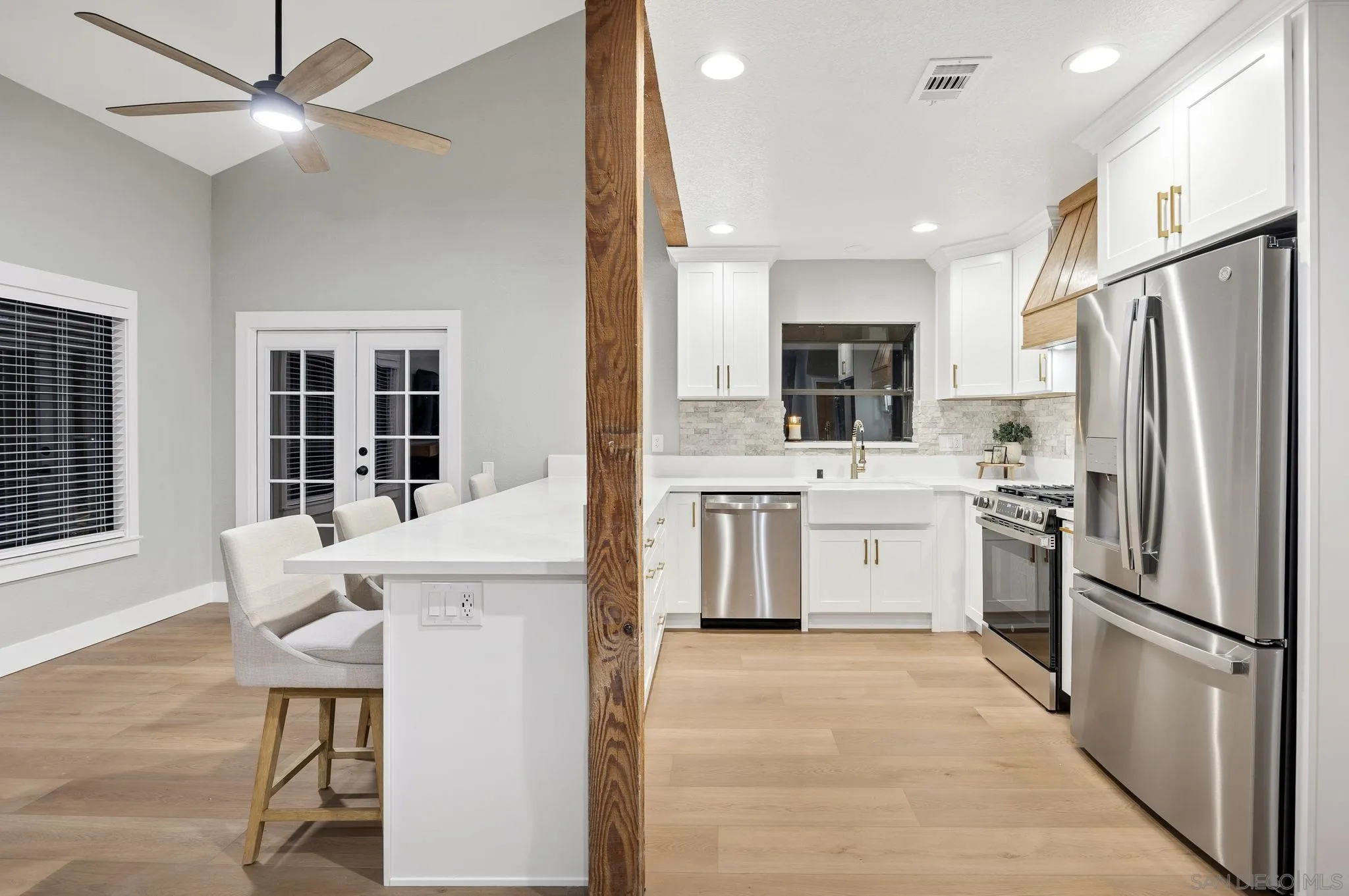 1590 Dorothea Avenue Fallbrook, CA 92028 - Photo 6 of 42 a kitchen with white cabinets and stainless steel appliances