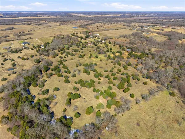 a view of field with trees in the background