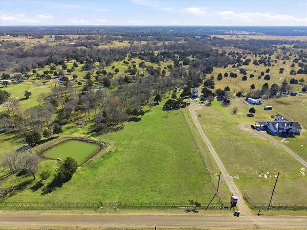 an aerial view of a residential houses with outdoor space