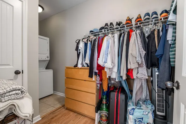 a view of walk in closet with clothes and shoes