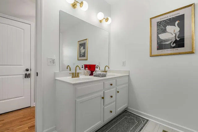 a bathroom with a sink vanity and a mirror